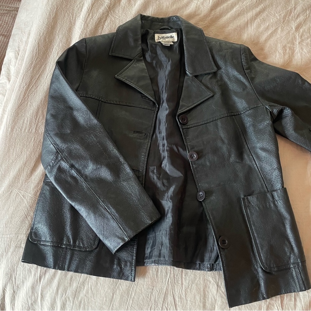 thrifted leather jacket from 90s. worn in, button up with collar. real leather